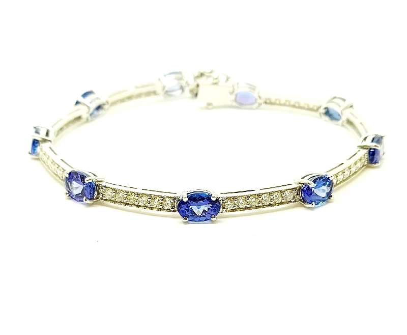 Ladies bracelets with shell charms -TANZANITE AND DIAMOND STATION BRACELET IN 14K WHITE GOLD AD NO # 2709